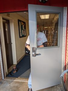 24-hr door service installing a pair of commercial steel doors