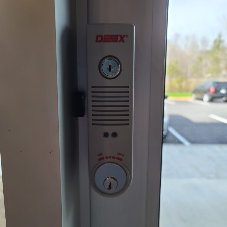 Key operated exit door alarm